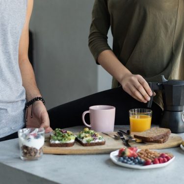 Cozy morning breakfast with avocado toast, coffee, and fresh juice.
